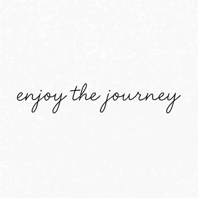 Delicate script phrase tattoo concept in black and grey, displaying the words 'enjoy the journey'; a project idea featuring graceful letters; not ideal for cover-up.