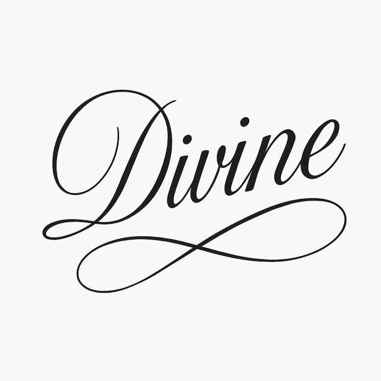Divine script tattoo in black ink, an elegant flowing word with flourishes; a black and grey project idea.